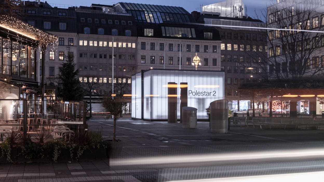 Side view of Norrmalmstorg and the Polestar cube with the text on the cube stating Polestar 2.
