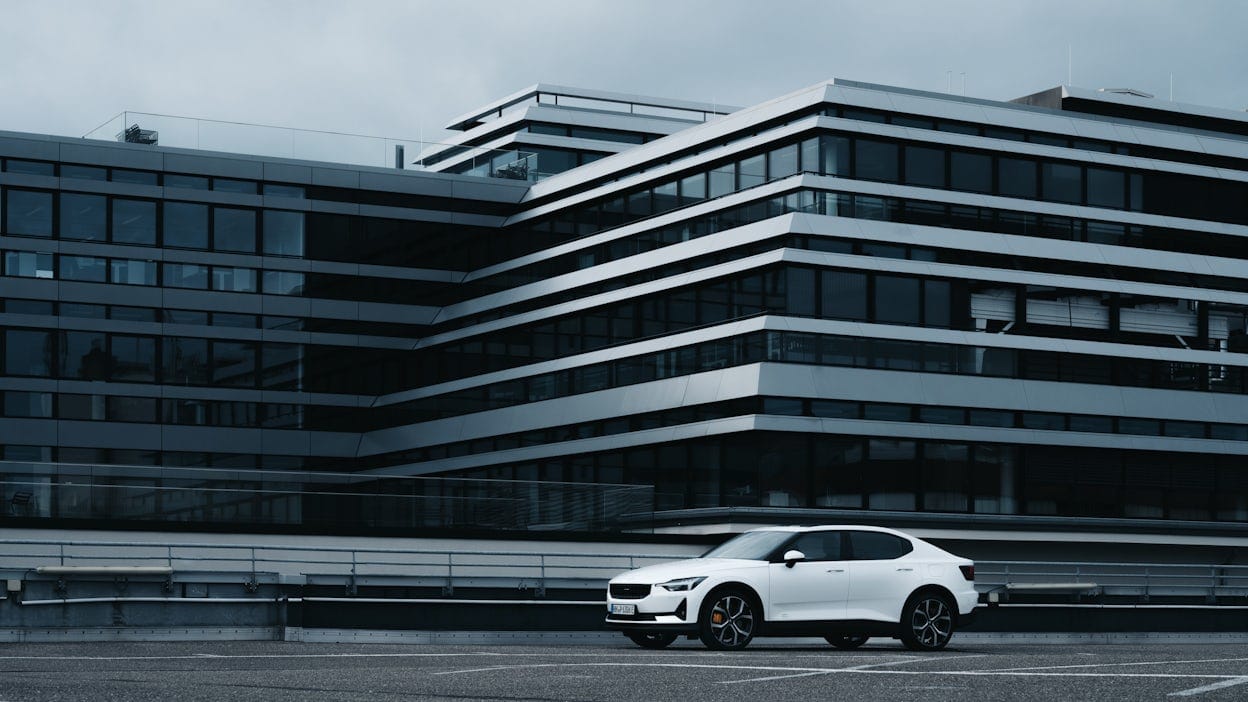 White Polestar 2 parked in front of an office building in Cologne.