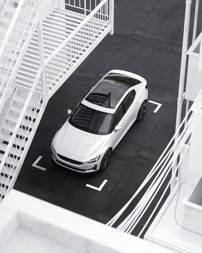 White Polestar 2 from above charging on a parking spot