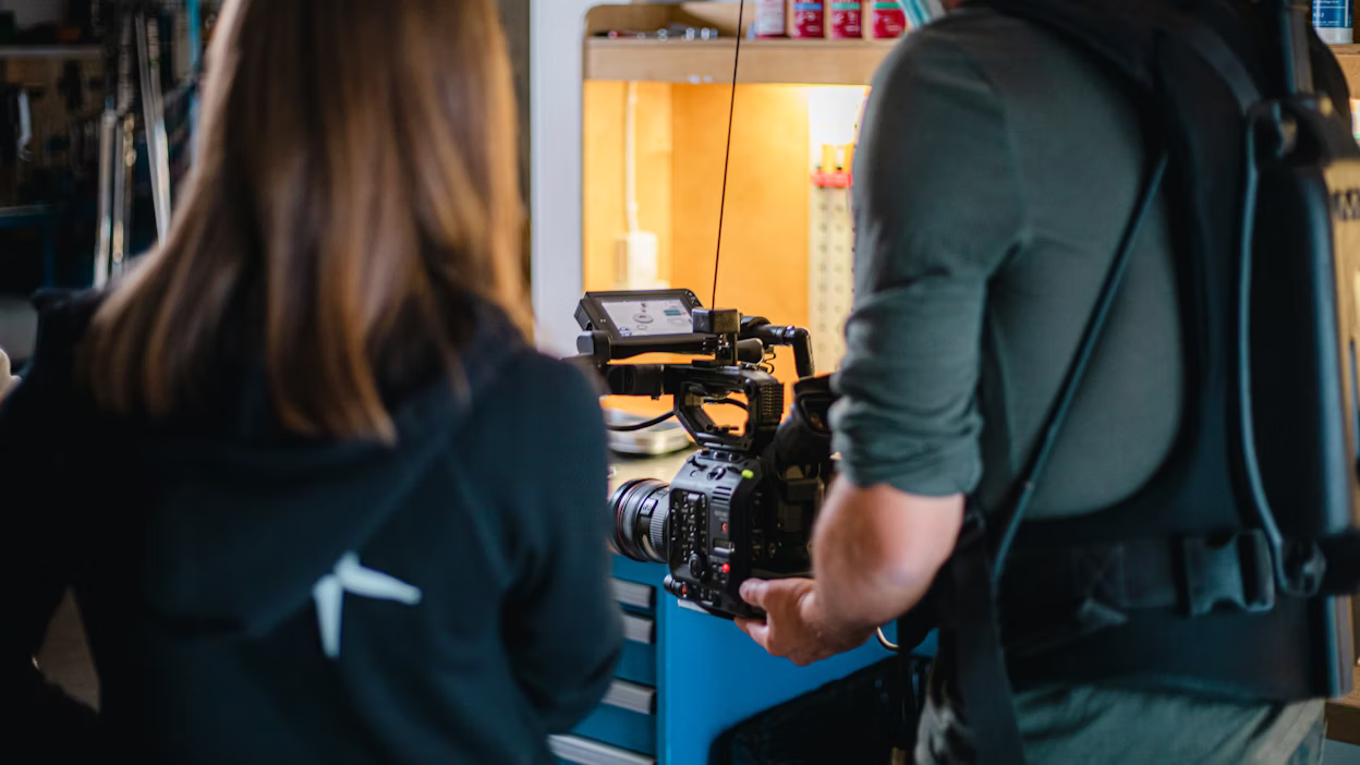 Cameraman filming behind the scenes at Öhlins headquarters.
