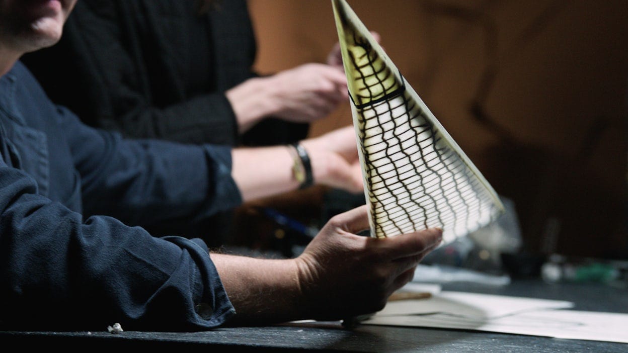 Two people working on a bio-based flax composite blade.