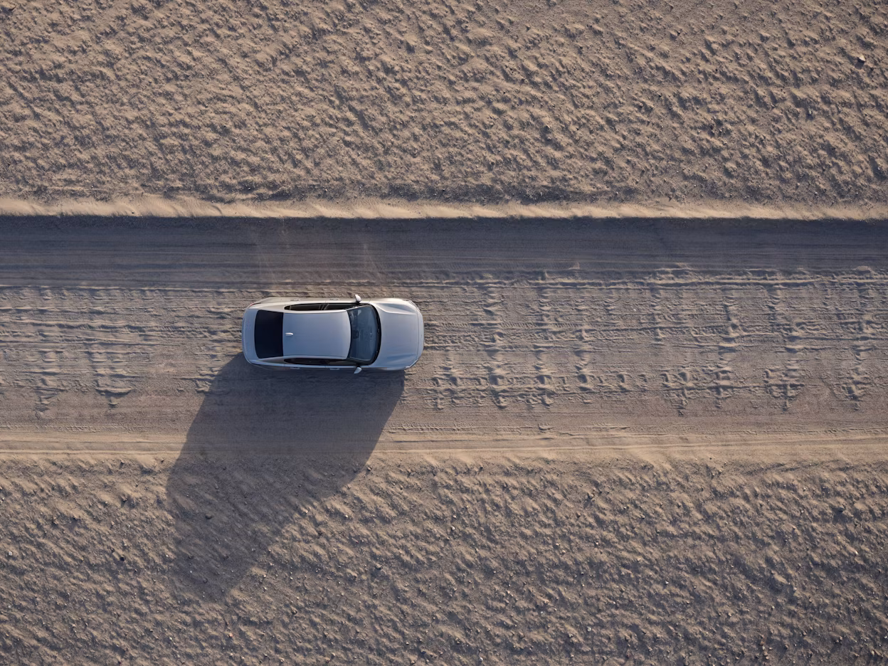 Bird's-eye view of Polestar 2 driving in desert landscape