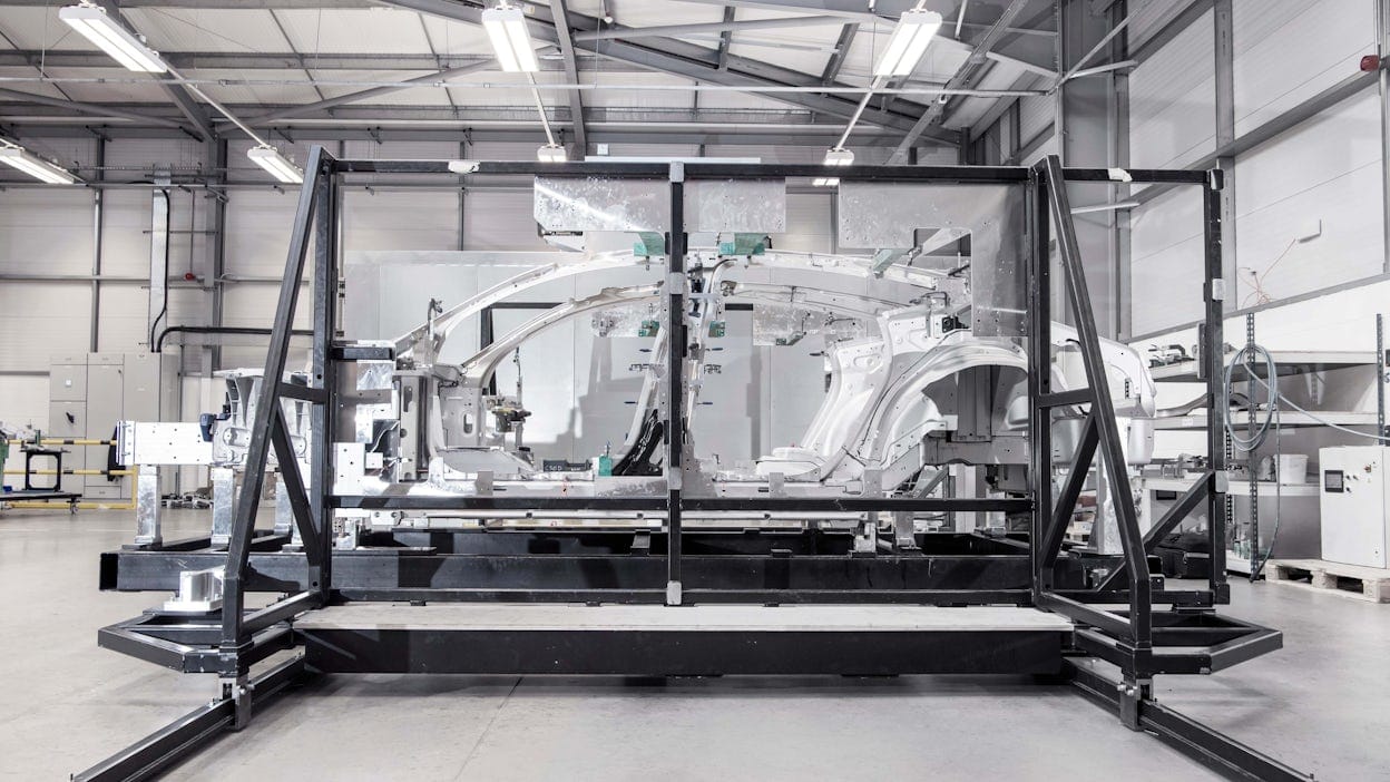 Side view of the bonded aluminium unibody of Polestar 5 in a workshop.