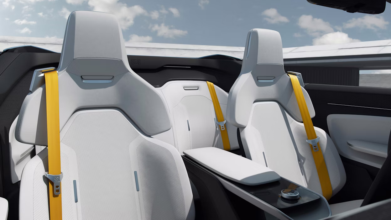 Light car seats inside Polestar o2 with golden seat belts