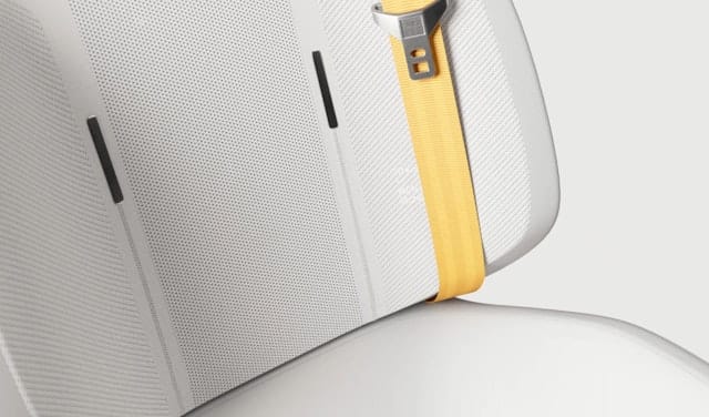 Close-up of a white seat and yellow seat belt