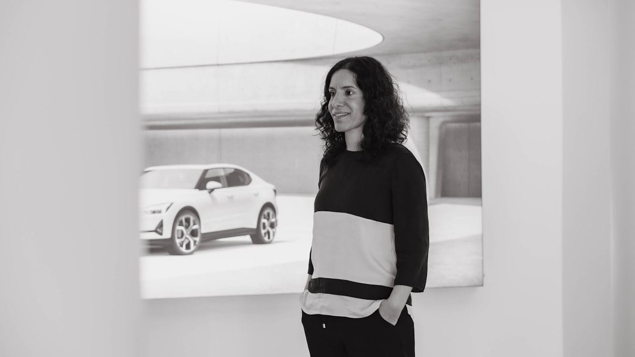 Mona Abbasi standing in front of a picture of a Polestar car.