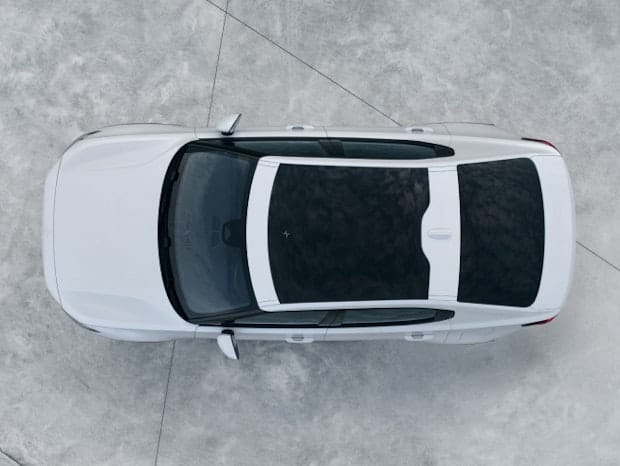 Birds view of Polestar 2 in colour Snow with a panoramic roof