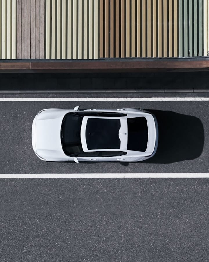 White Polestar 2 from above driving on the road