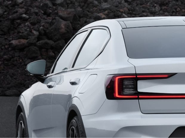 Rear side view of Polestar 2 in colour Snow and it's tail light 