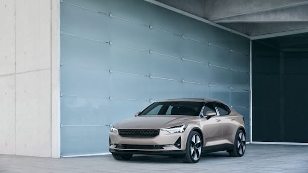 A Polestar 2 in front of a glass wall.