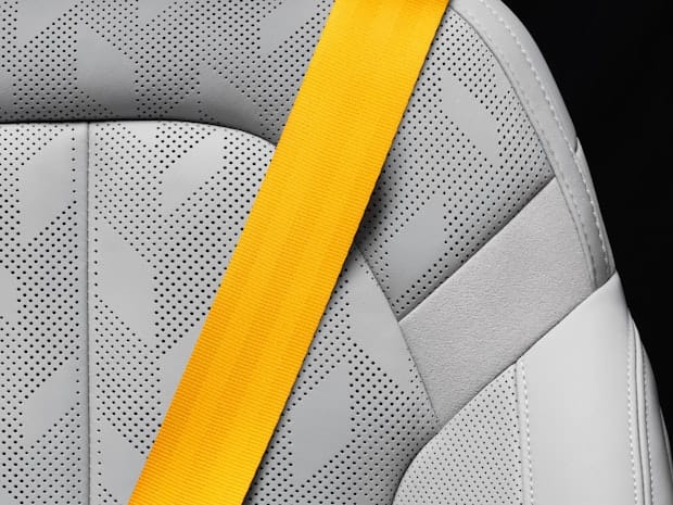 Polestar 2 interior performance pack Swedish gold seat belt close up.