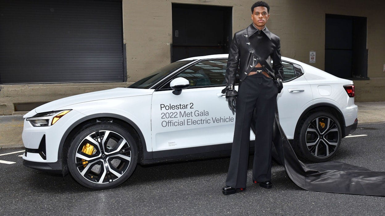 Jeremy Pope in front of a Polestar 2. 