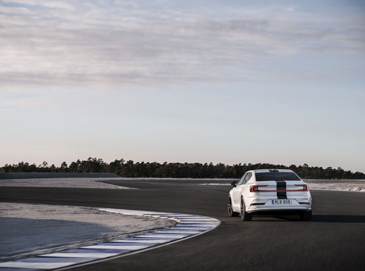A Polestar 2 featuring a racing stripe on a track. 