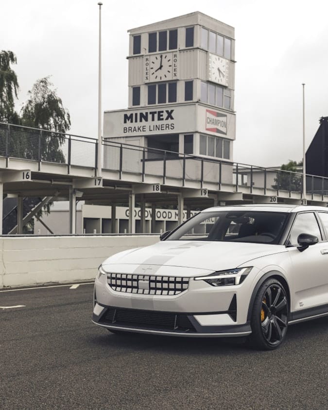 Polestar 2 BST edition 270 in colour Snow and race stripe adorned in pole position on a racing track