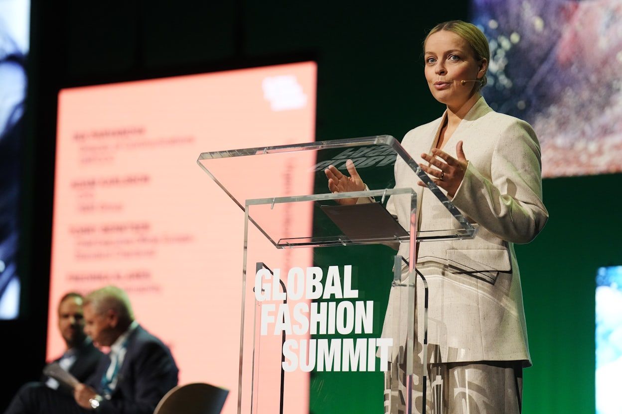 Fredrika Klarén speaking by the podium at the Global Fashion Summit.