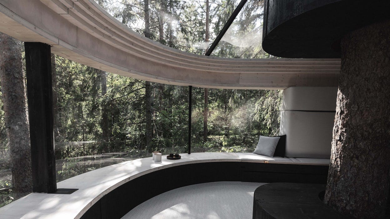 The interior of a treehouse with large windows.