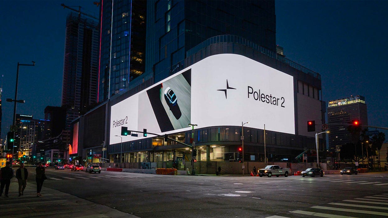 Polestar 2 digital billboard displayed on building in the city night lights.