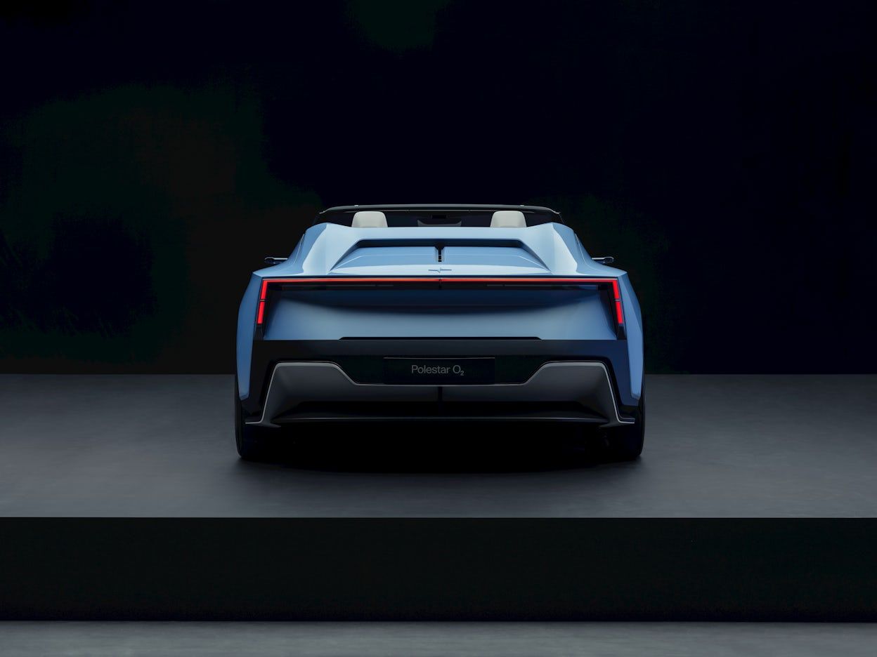 Rear view of a blue Polestar O₂ electric roadster.