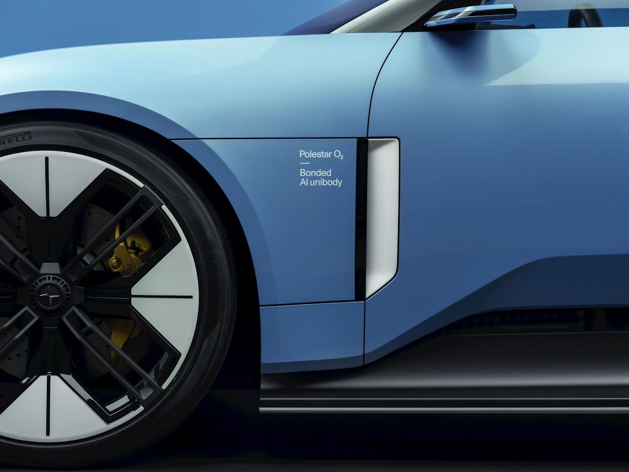 A close-up of the side panels of a blue Polestar O₂ convertible.