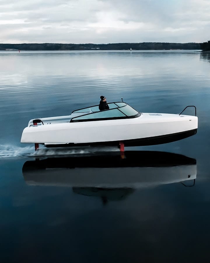 A white boat on the water, as seen from the side.