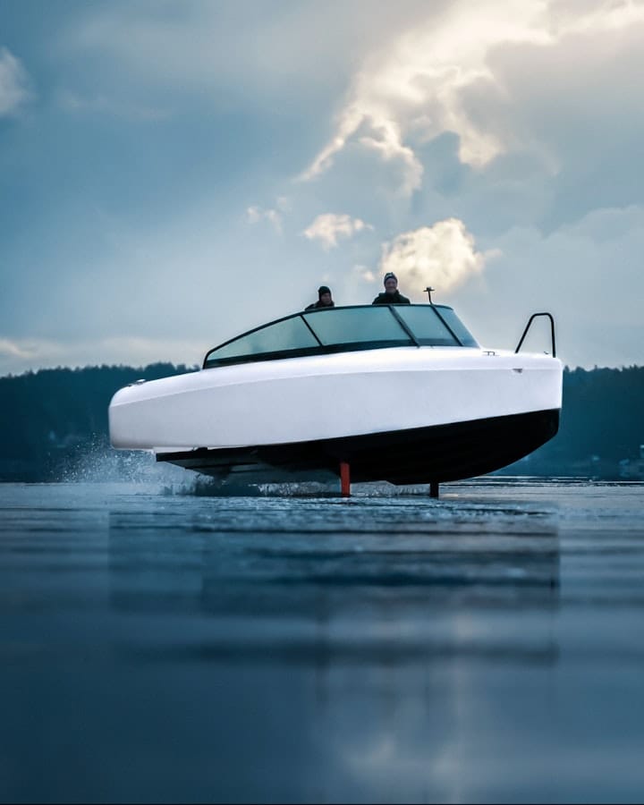 A white boat on the water, seen from the front.