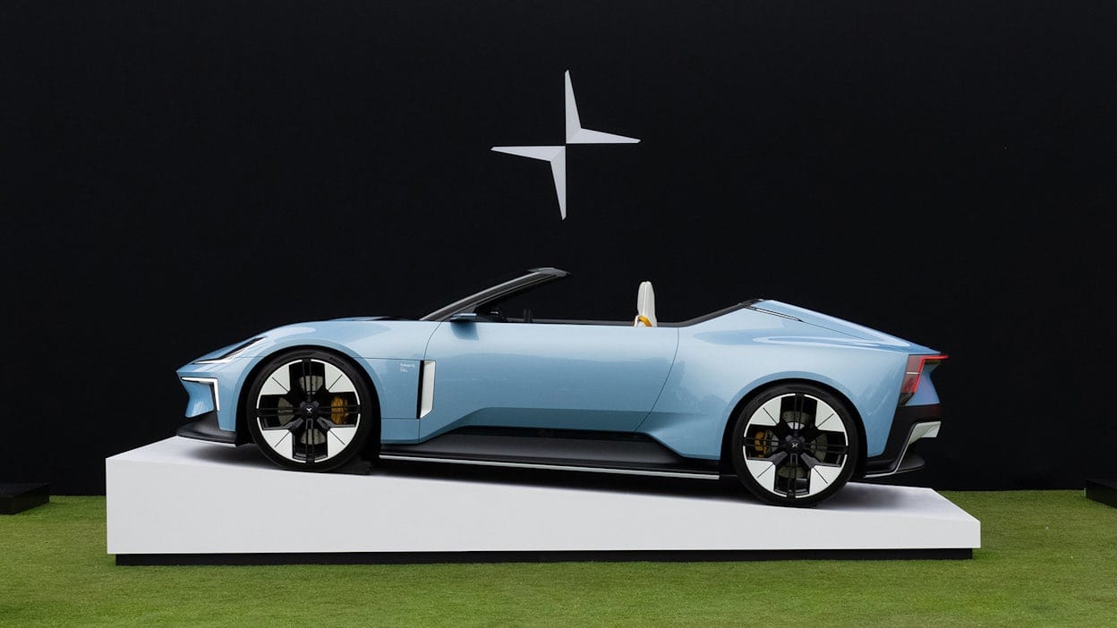 Side view of a light blue Polestar 6 in a exhibition space at Pebble Beach.
