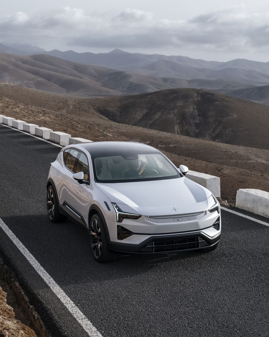 A Polestar 2 drives on a road.