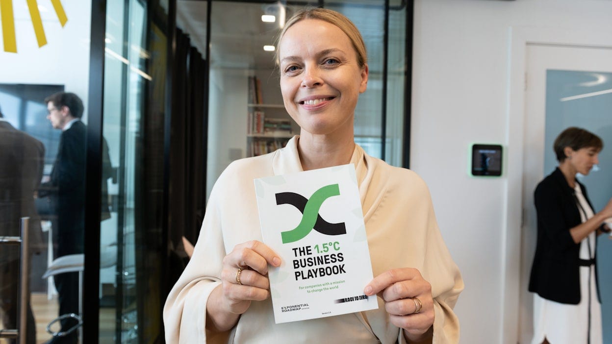 Fredrika Klarén holding The 1.5°C Business Playbook
