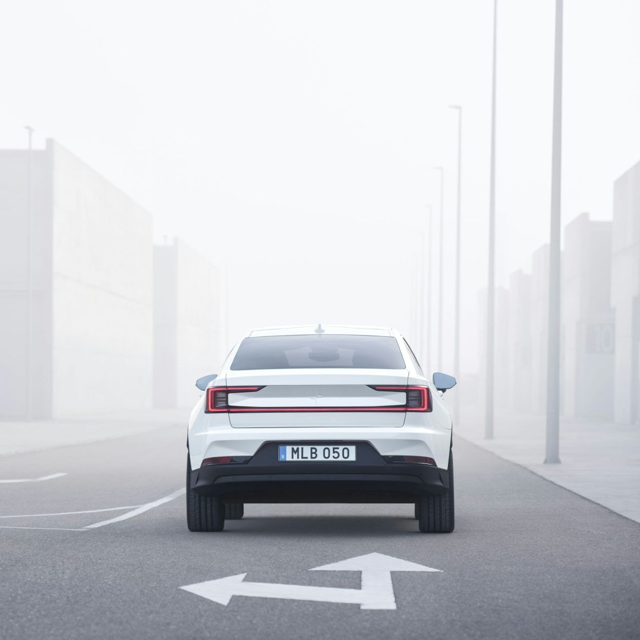Polestar 2 drives forward on a road in a foggy environment