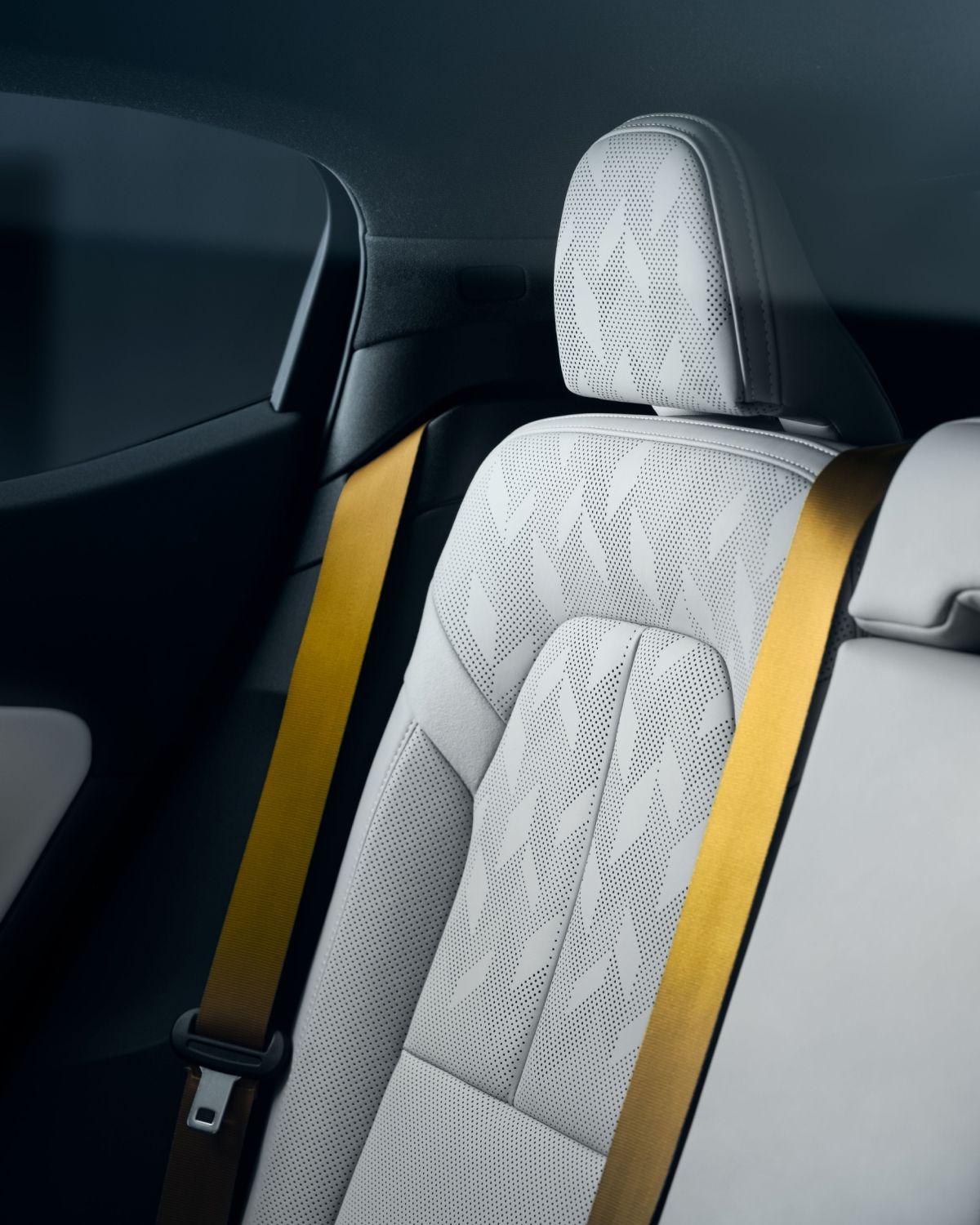 Backseat of the Polestar 2, light leather and yellow belts