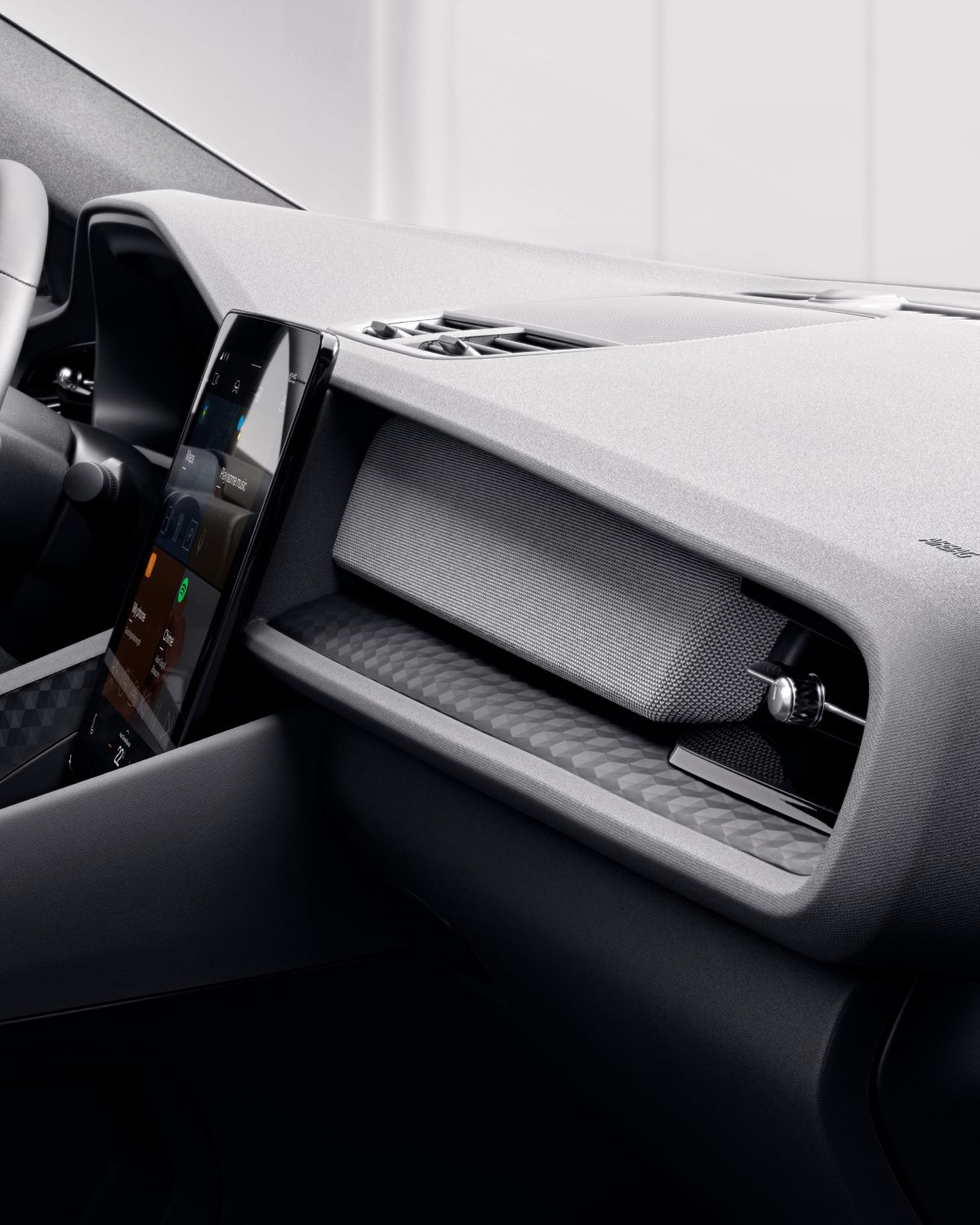 Dashboard for Polestar 2, focus on the integrated grey subwoofer