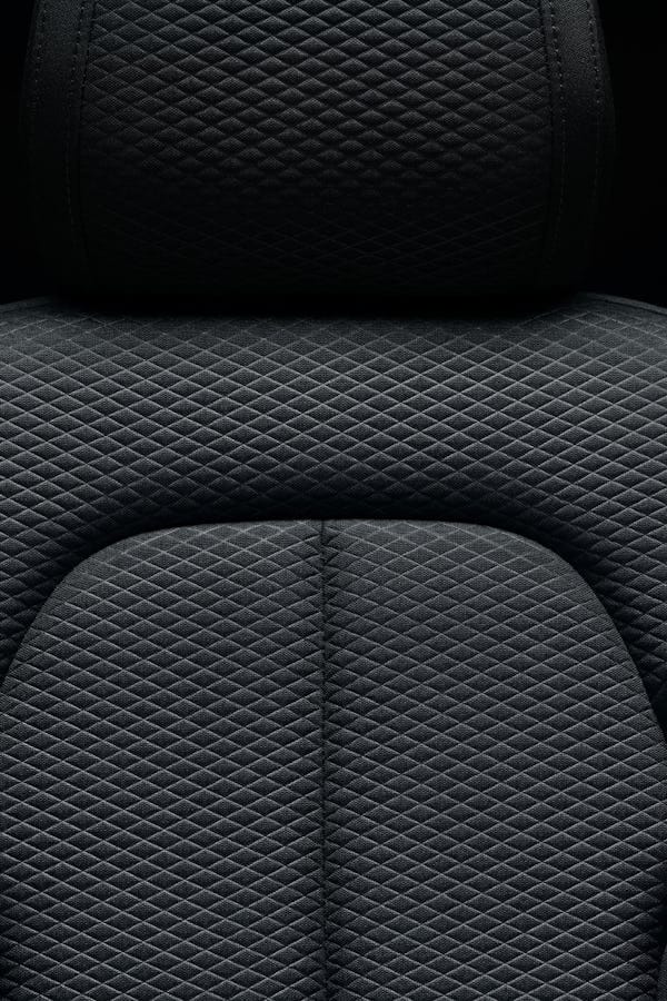 Close-up on dark upholstery and black background
