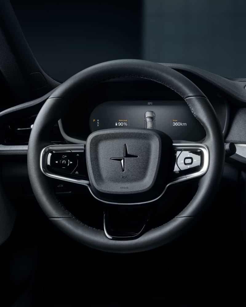 Focus on black steering wheel with Polestar logo and dashboard in the background