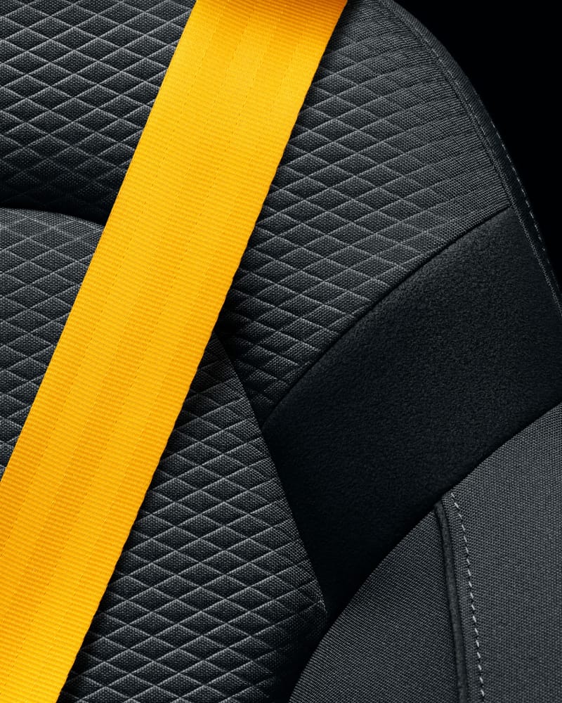 Seatbelt in yellow/golden on a dark seat