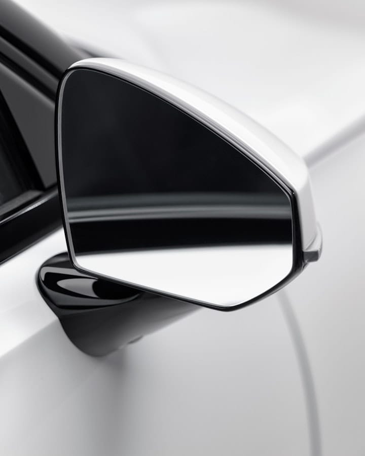 Close-up of a side mirror on a white Polestar 2