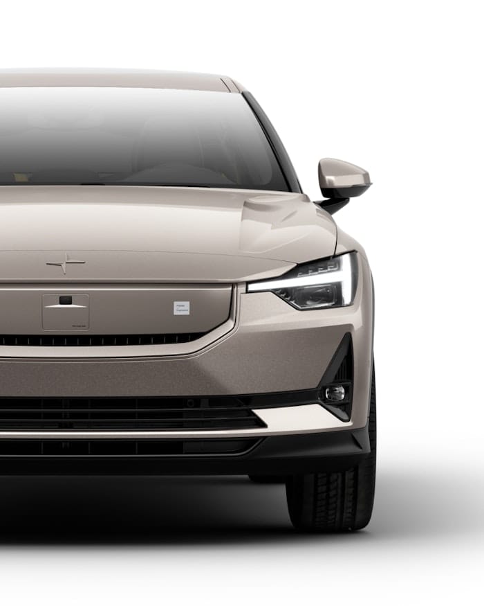 A front view of the Polestar 2 with a warm metallic exterior.