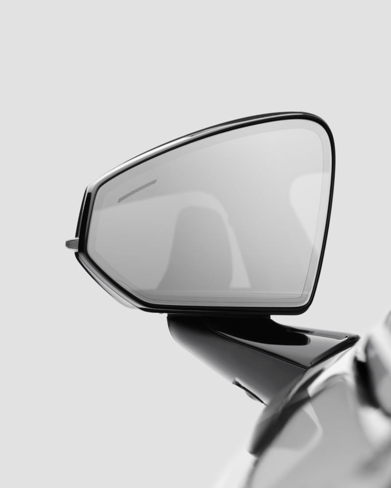 Close-up on the frameless door mirror, light grey background.