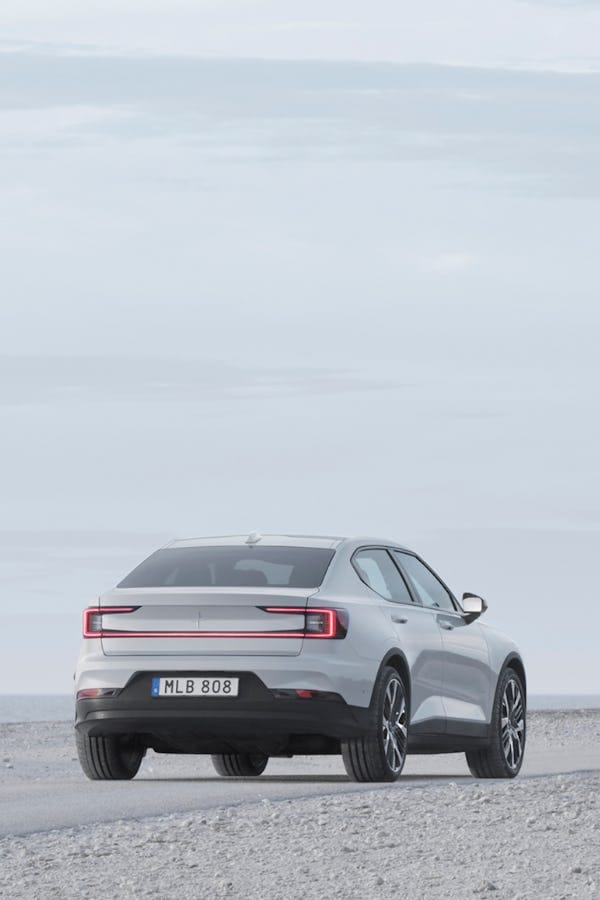 White Polestar 2 charging. Showing from behind