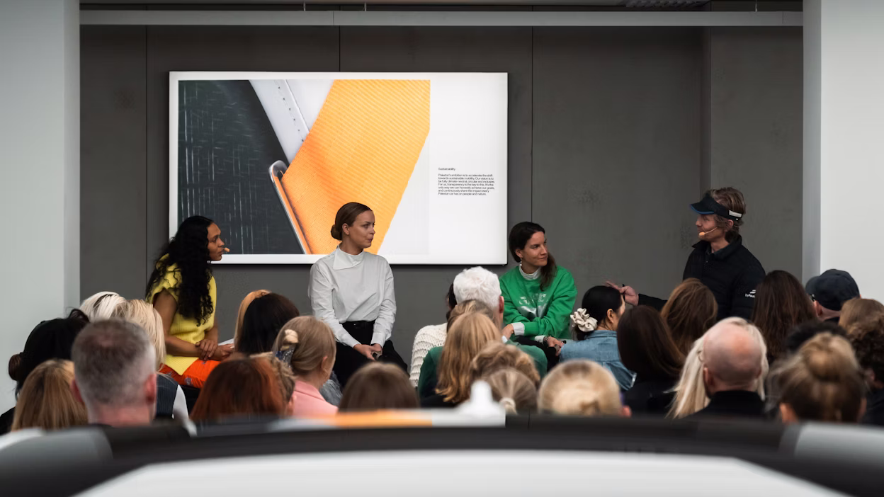 People talking in front of a group of people in a Polestar space