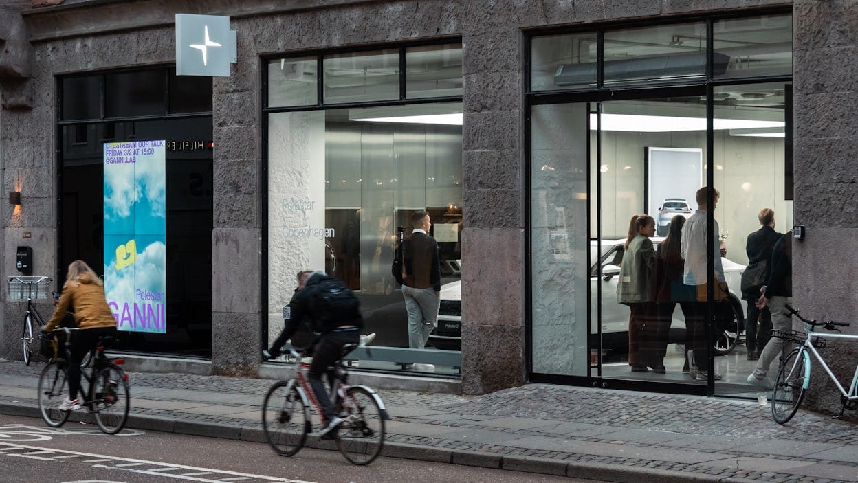 The Polestar space in Copenhagen filled with enthusiastic visitors, as seen from outside looking in.