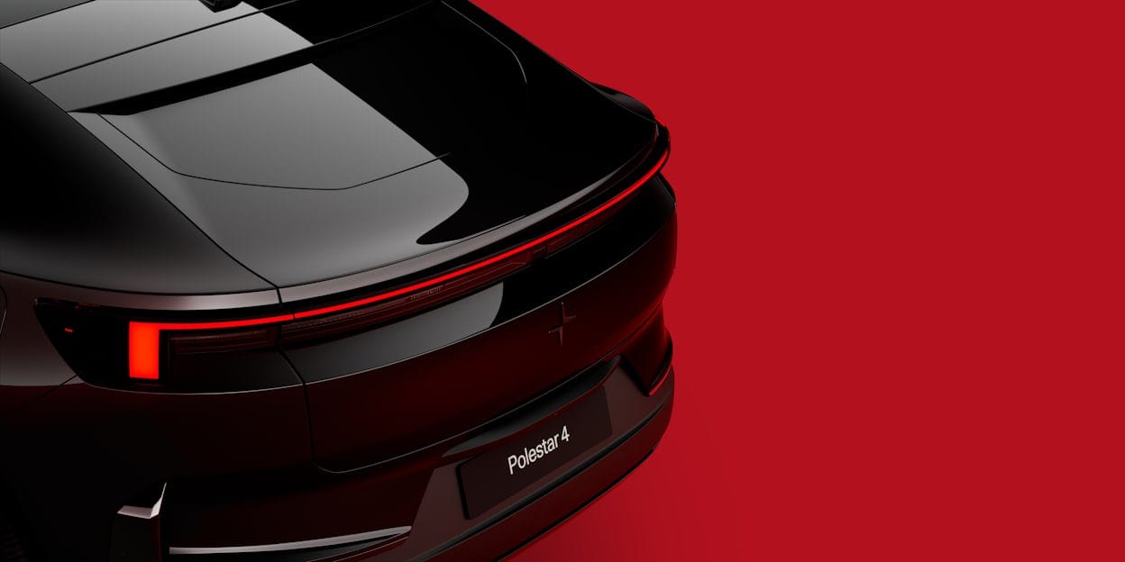 The back of a black Polestar 4. Red background