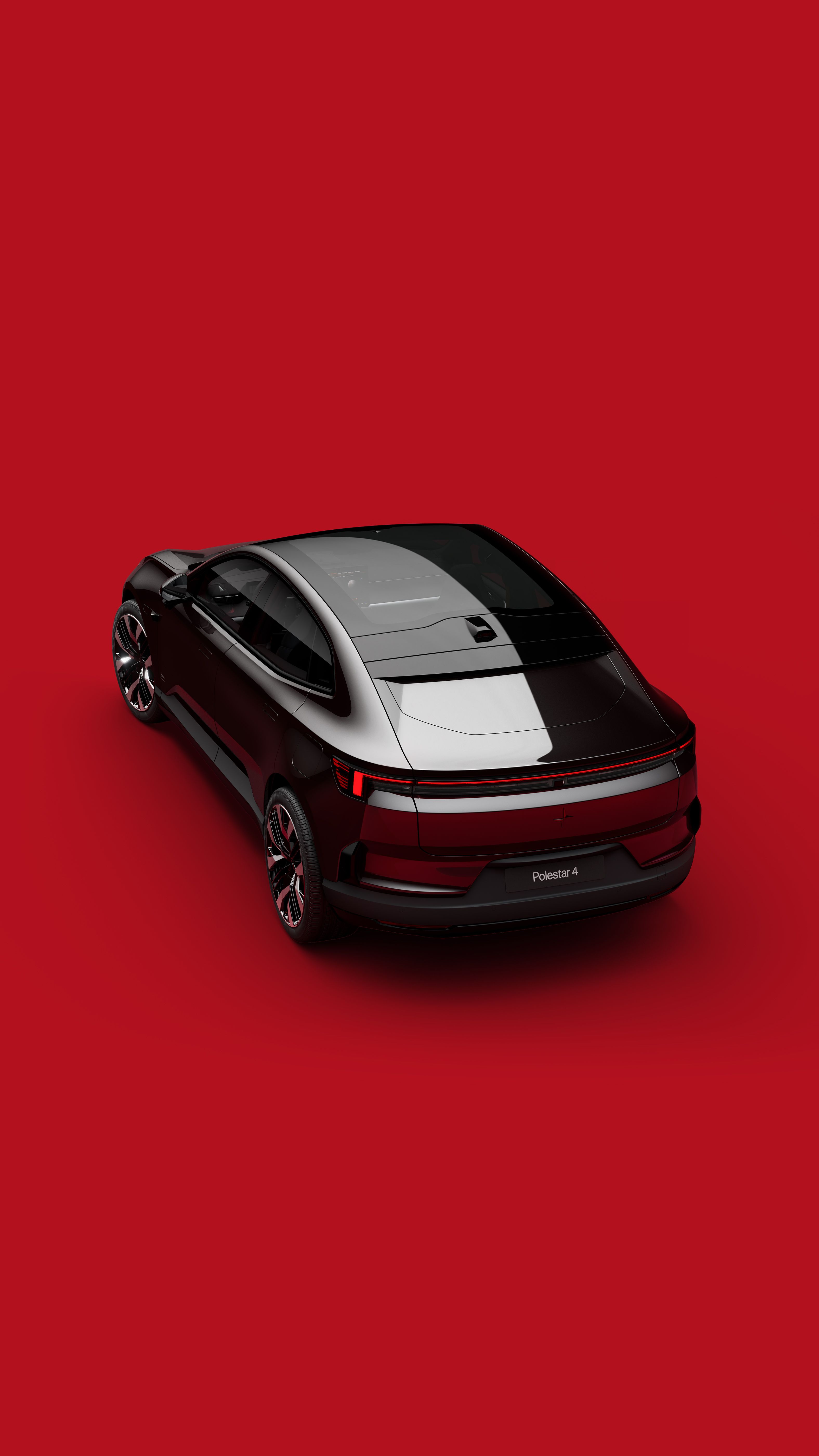 Black Polestar 4 seen obliquely from behind. Red background