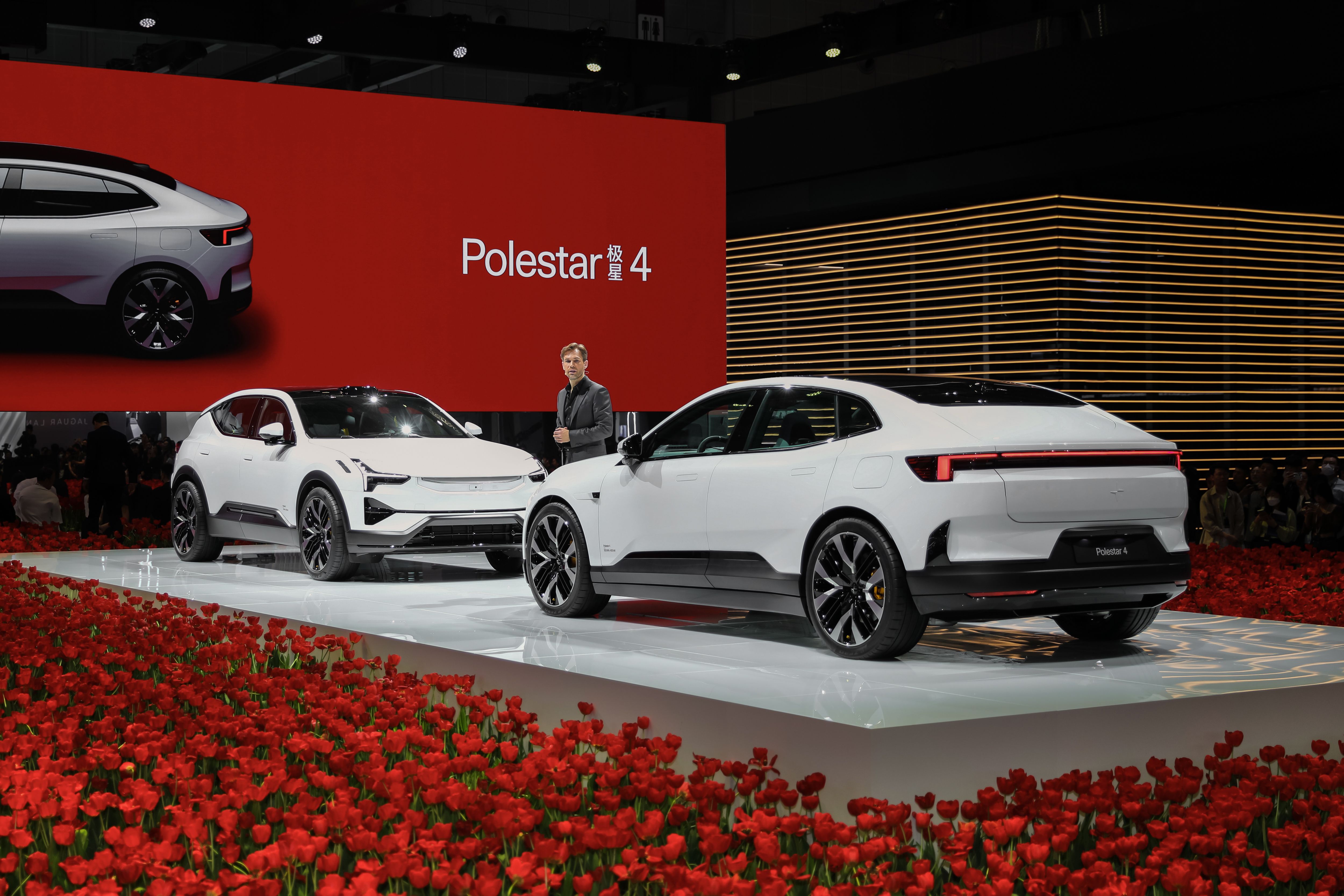 The launch of Polestar 4, Polestar 3 and 4 on stage together with a man