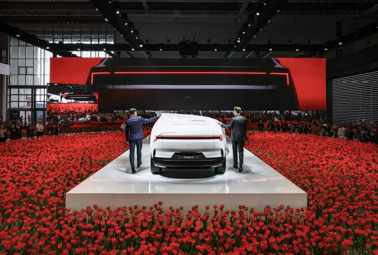 Polestar 4 being released on stage in a field on red tulips