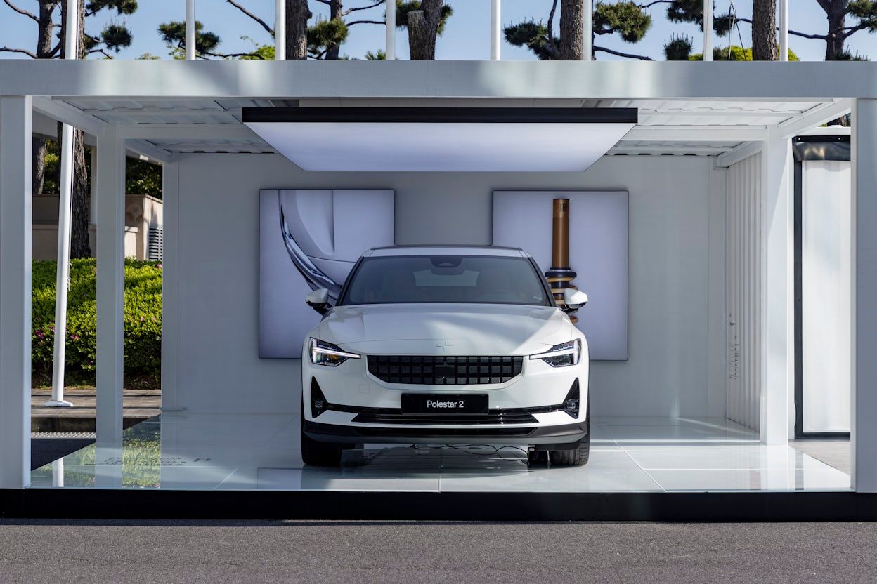 Front of Polestar 2 staning in a outdorr space.