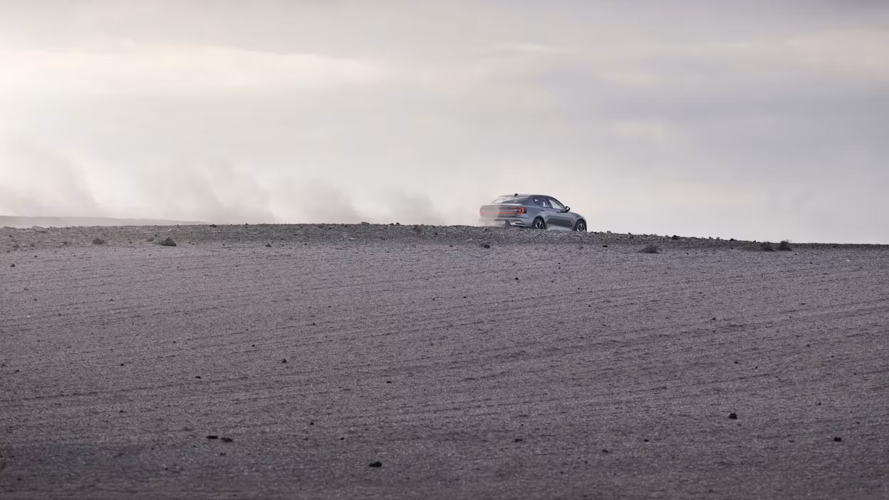 Polestar 2 driving in a desert looking environment