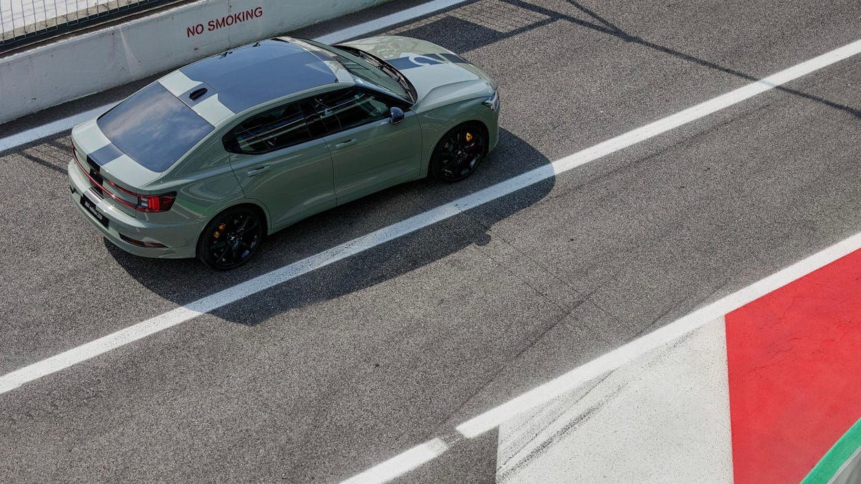 Bird's-eye view of a green Polestar 2 on a racing track.