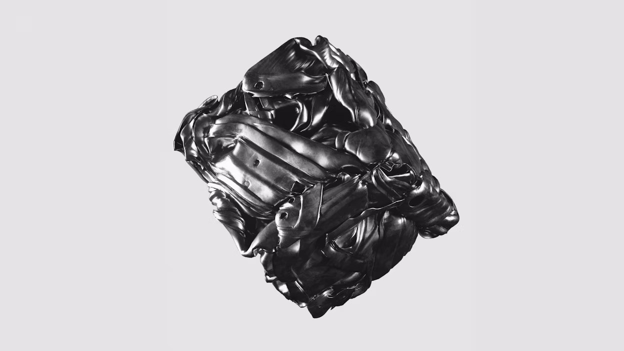 Abstract metallic sculpture with folded and contorted shapes on a light gray background.