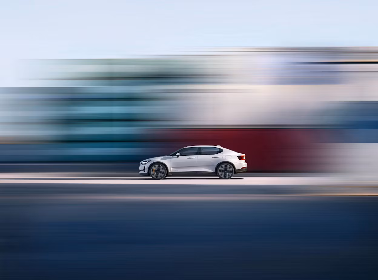 Polestar 2 seen from above, blurry vertical background in red and white