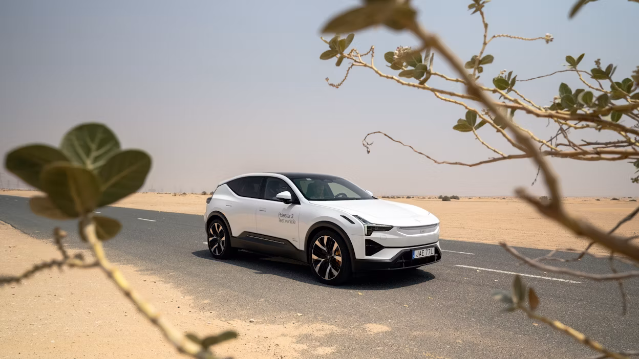 Side view of Polestar 3 framed by desert bush